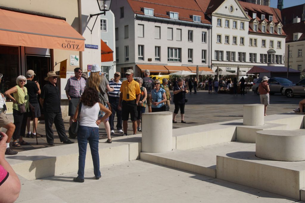 Tourists at the holocaust memorial in Regensburg, germany