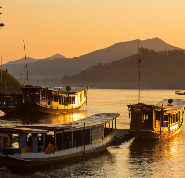 Boats on the Mekong river at dusk. (APT Essential Vietnam & Cambodia tour)