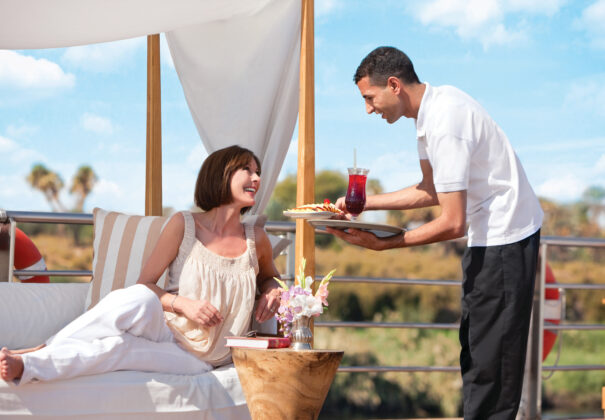 Woman receiving a drink on the all inclusive Nile cruise ship River Tosca